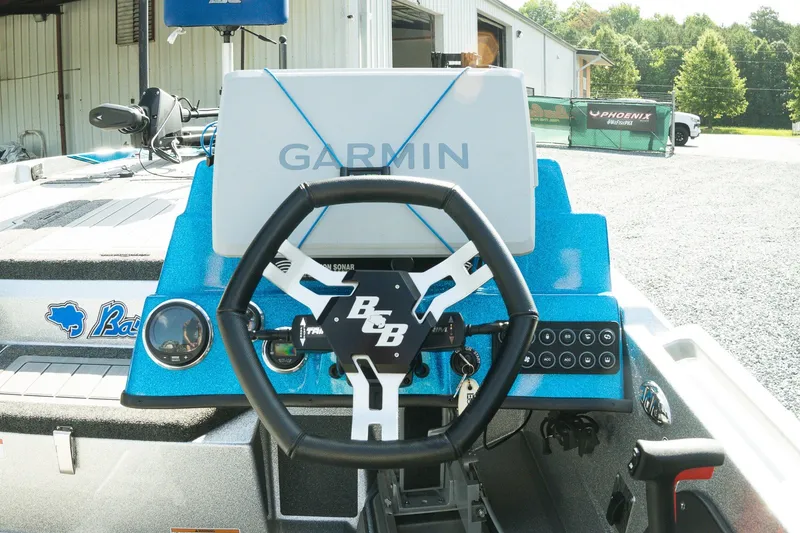 Slide: The Image of 2026 Bass Cat Lynx STS boat dashboard with Garmin navigation system and steering wheel. - 14