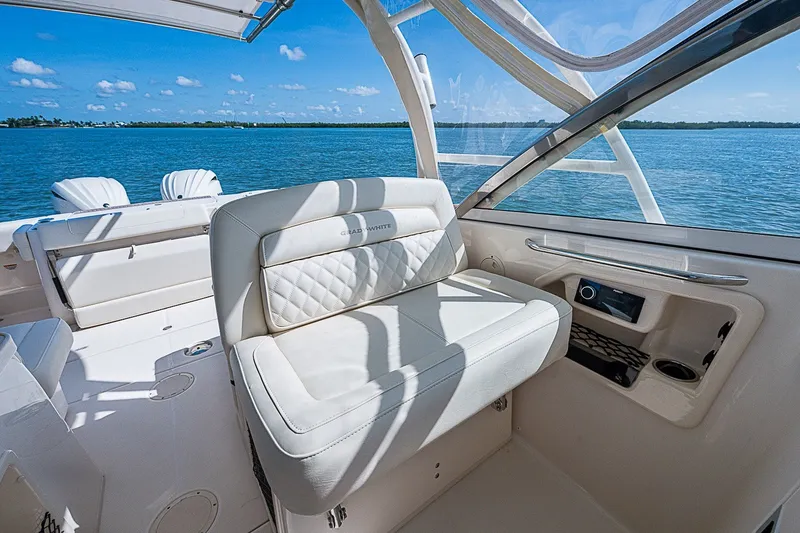 Slide: The Image of 2024 Grady-White Freedom 307 boat interior with luxurious seating and ocean view. - 27