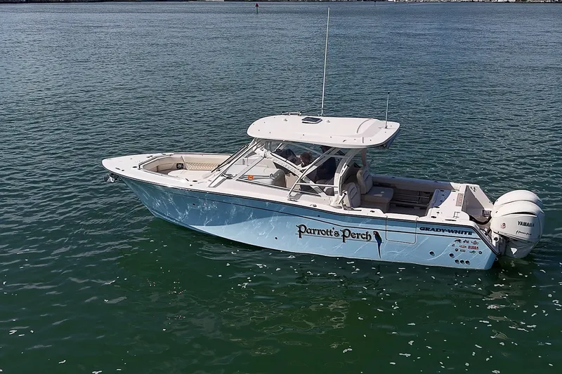 Slide: The Image of 2024 Grady-White Freedom 307 boat on water, featuring sleek design and twin Yamaha engines. - 43