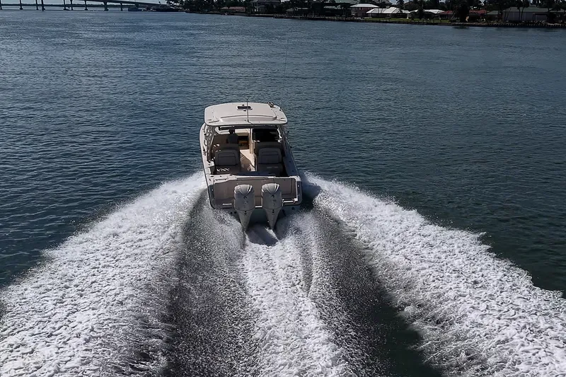 Slide: The Image of 2024 Grady-White Freedom 307 cruising on open water, rear view. - 46