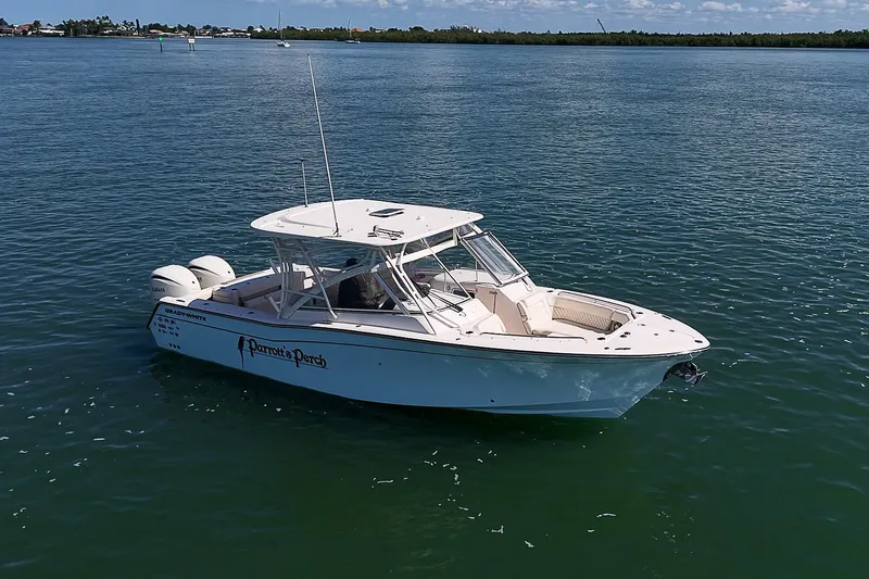 Slide: The Image of 2024 Grady-White Freedom 307 boat on calm water, side view. - 38