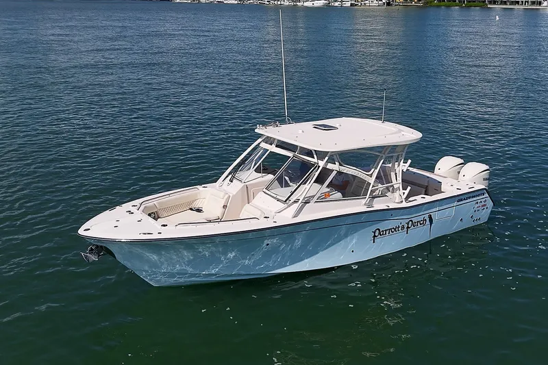 Slide: The Image of 2024 Grady-White Freedom 307 boat on calm water, side view. - 40