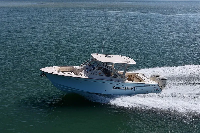 Slide: The Image of 2024 Grady-White Freedom 307 boat cruising on open water, side view. - 54