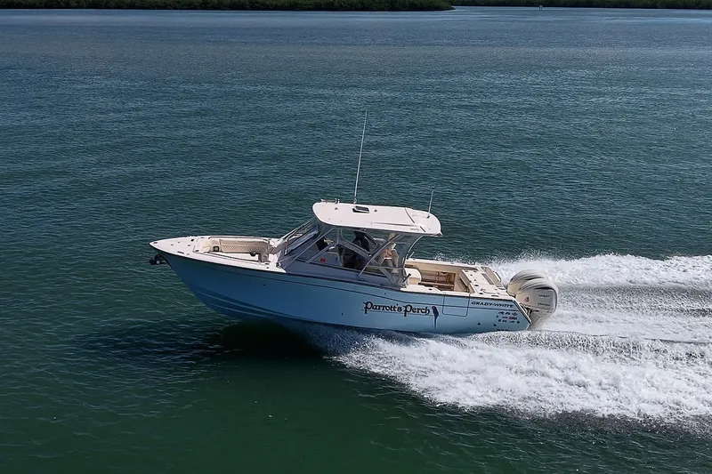 Slide: The Image of 2024 Grady-White Freedom 307 boat cruising on open water, side view. - 53