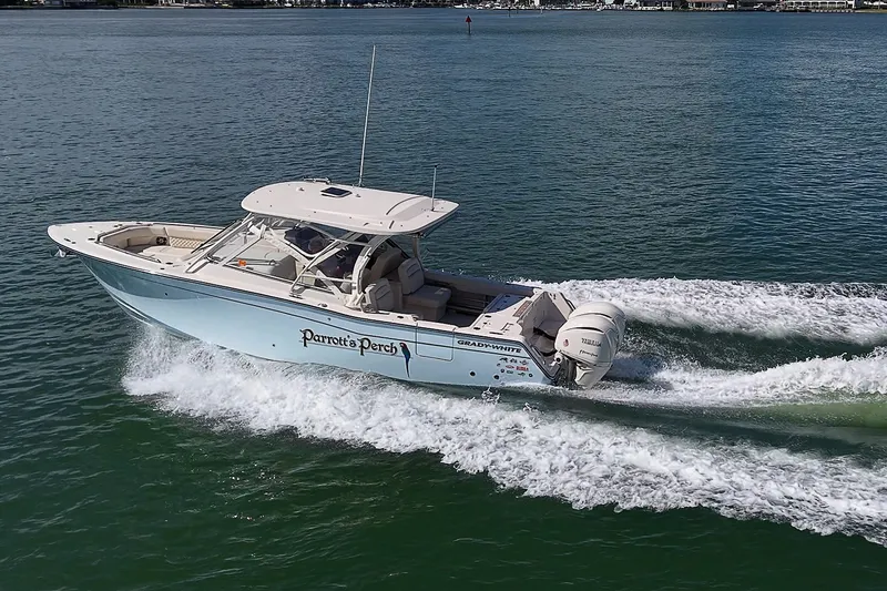 Slide: The Image of 2024 Grady-White Freedom 307 boat cruising on open water, side view. - 45