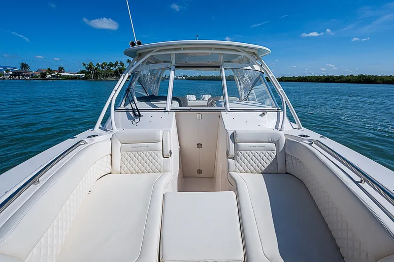 Slide: The Image of 2024 Grady-White Freedom 307 boat interior with luxurious seating on a sunny day. - 35