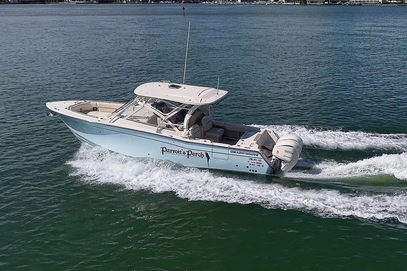 Slide: The Image of 2024 Grady-White Freedom 307 boat cruising on open water. - 44
