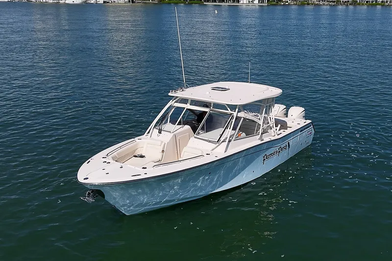 Slide: The Image of 2024 Grady-White Freedom 307 boat on calm water, showcasing sleek design and spacious deck. - 39