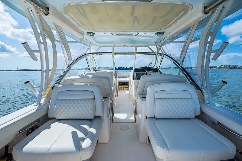Slide: The Image of 2024 Grady-White Freedom 307 boat interior with luxurious seating and ocean view. - 23