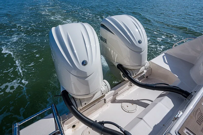 Slide: The Image of 2024 Grady-White Freedom 307 boat with dual Yamaha outboard engines on water. - 14