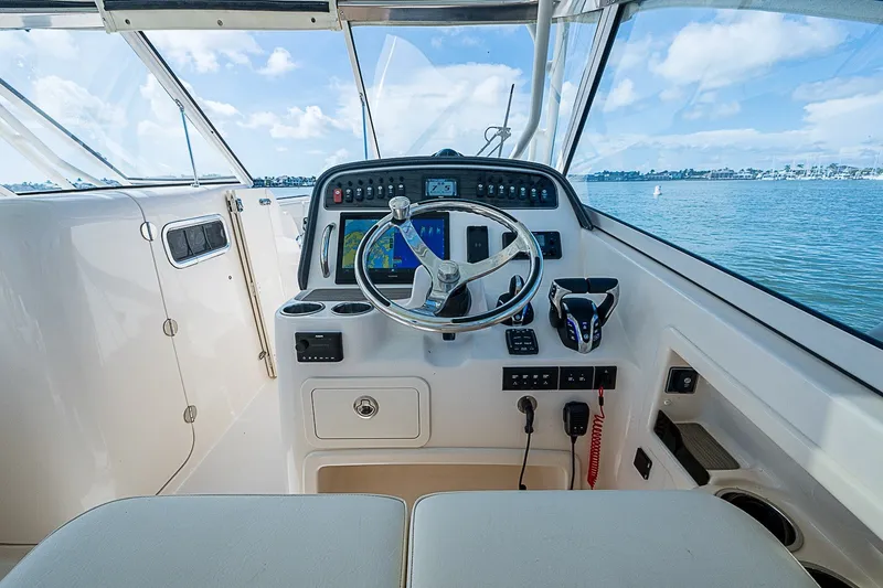 Slide: The Image of 2024 Grady-White Freedom 307 boat helm with steering wheel and navigation system. - 31