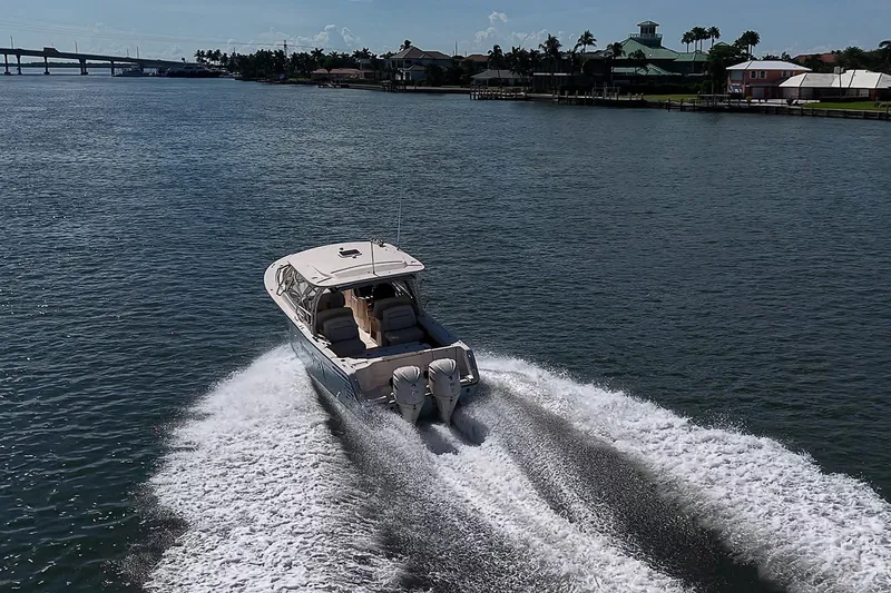 Slide: The Image of 2024 Grady-White Freedom 307 boat cruising on a scenic waterway. - 48