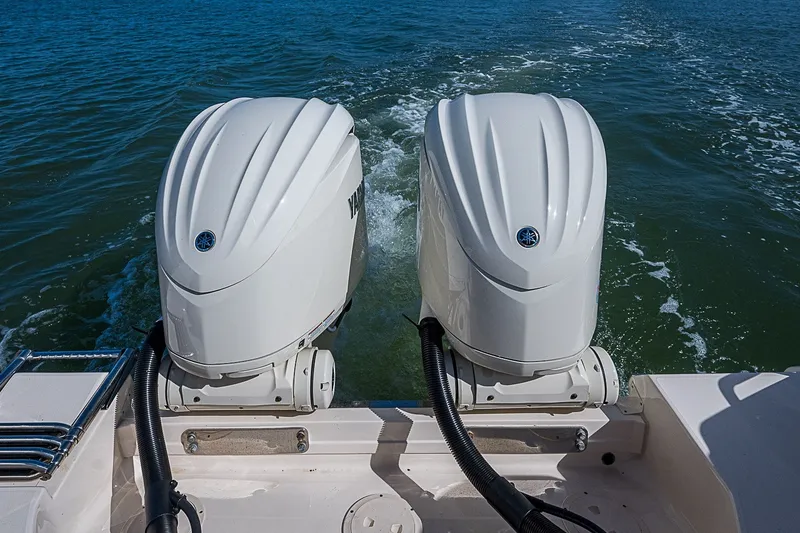 Slide: The Image of Twin outboard engines on a 2024 Grady-White Freedom 307 boat in open water. - 15