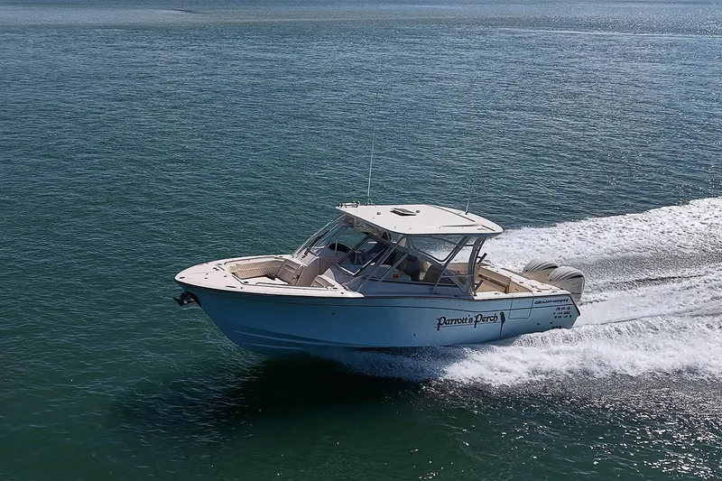 Slide: The Image of 2024 Grady-White Freedom 307 boat cruising on open water. - 55