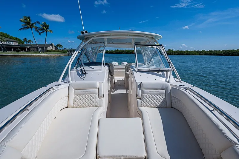 Slide: The Image of 2024 Grady-White Freedom 307 boat interior with luxurious seating on a sunny day. - 34