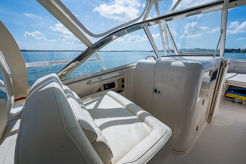 Slide: The Image of 2024 Grady-White Freedom 307 boat interior with ocean view and luxurious seating. - 26