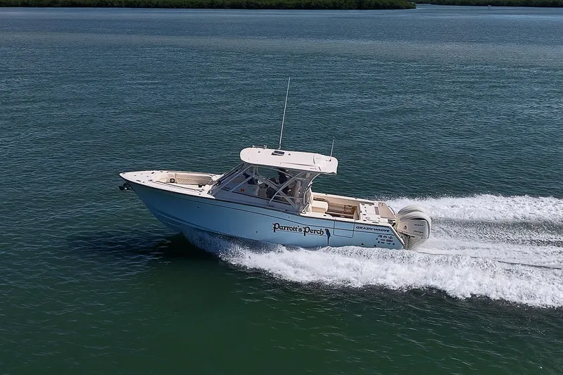 Slide: The Image of 2024 Grady-White Freedom 307 boat cruising on open water. - 51