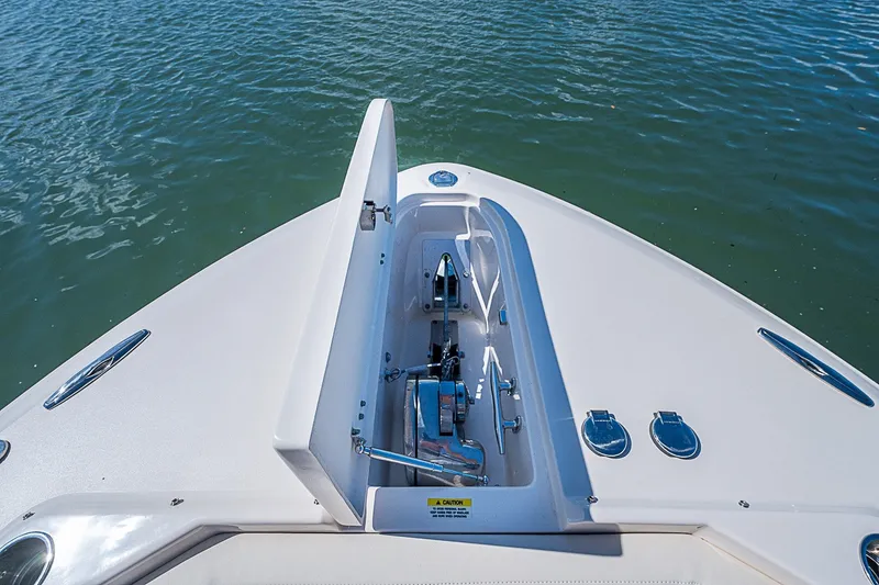 Slide: The Image of 2024 Grady-White Freedom 307 boat anchor compartment, open on calm water. - 36
