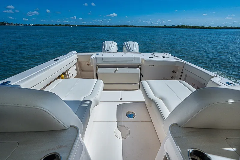 Slide: The Image of 2024 Grady-White Freedom 307 boat interior with spacious seating on open water. - 24