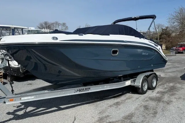 The Image of 2026 Hurricane SunDeck 2600 OB boat on trailer, parked outdoors. - 0