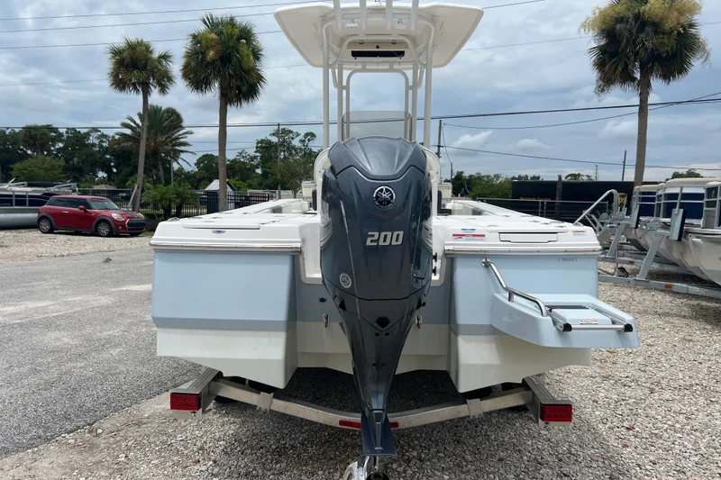 Slide: The Image of 2024 Robalo 226 Cayman boat with Yamaha 200 engine, parked on gravel lot. - 3