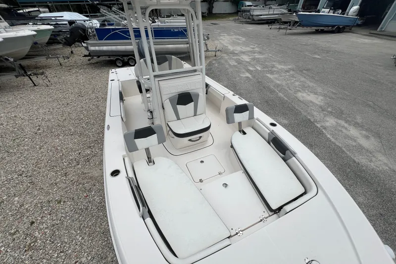 Slide: The Image of 2024 Robalo 226 Cayman boat with spacious seating and sleek design in a marina setting. - 14