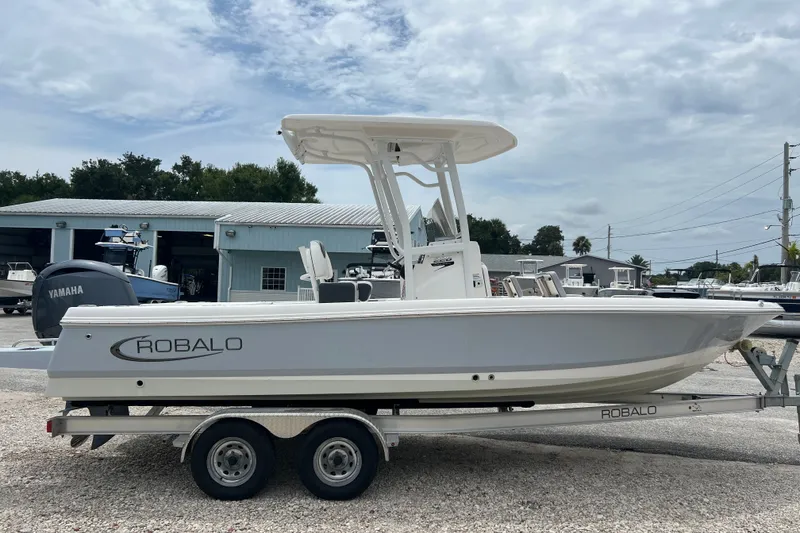 Slide: The Image of 2024 Robalo 226 Cayman boat on trailer, side view, with Yamaha engine, outdoors. - 5