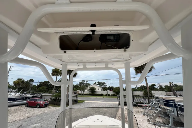 Slide: The Image of 2024 Robalo 226 Cayman boat T-top with electronics compartment, outdoor setting. - 12