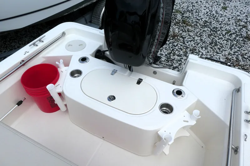 Slide: The Image of 2027 Boston Whaler 150 Montauk boat stern with motor, red bucket, and rod holders. - 4