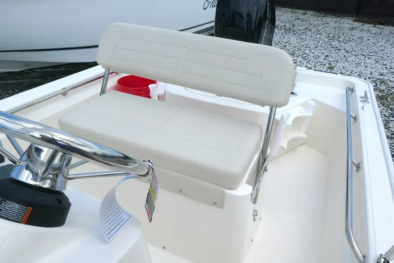Slide: The Image of 2027 Boston Whaler 150 Montauk boat interior with steering wheel and seating. - 7