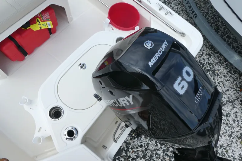 Slide: The Image of 2027 Boston Whaler 150 Montauk with Mercury 60 CT outboard motor, featuring onboard storage. - 5