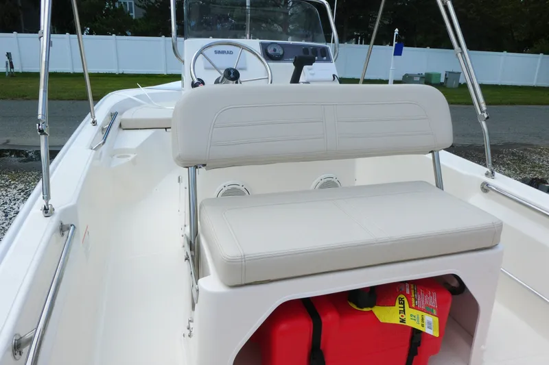 Slide: The Image of 2027 Boston Whaler 150 Montauk boat interior with seating and storage compartment. - 6