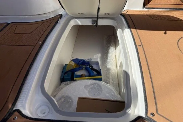 Slide: The Image of Storage compartment of 2026 Hurricane SunDeck 2690 OB boat, featuring organized equipment. - 14
