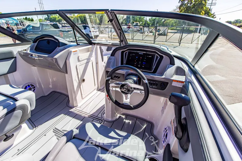Slide: The Image of Interior view of 2026 Chaparral 21 SSi OB boat, featuring modern dashboard and steering wheel. - 23