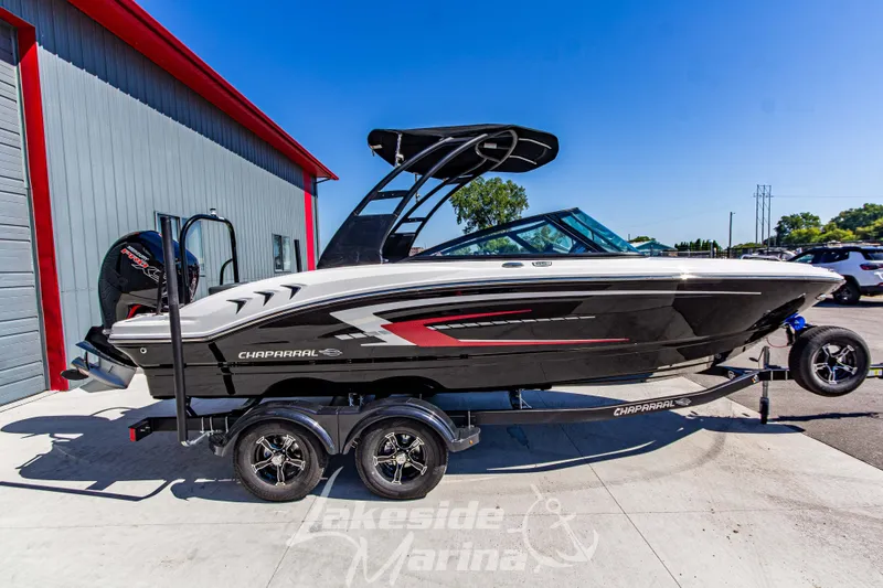 Slide: The Image of 2026 Chaparral 21 SSi OB boat on trailer at Lakeside Marina, sunny day. - 4