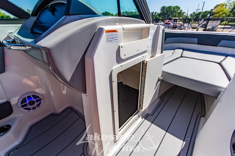 Slide: The Image of Interior view of 2026 Chaparral 21 SSi OB boat, featuring seating and storage compartment. - 29