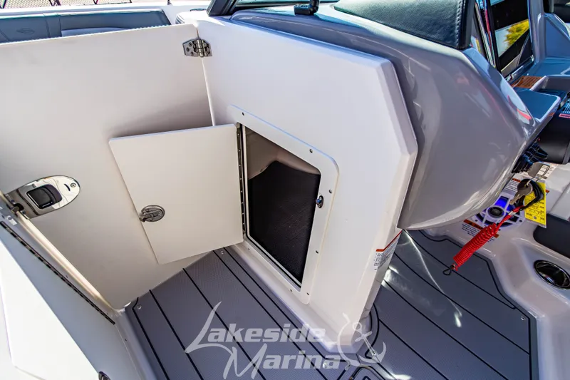 Slide: The Image of 2026 Chaparral 21 SSi OB boat interior with open storage compartment and sleek design. - 28