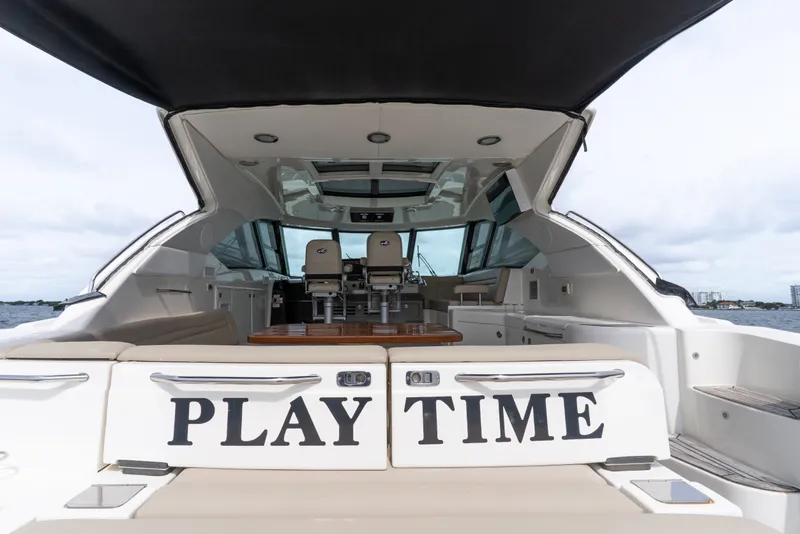 Slide: The Image of 2016 Sea Ray Sundancer 540 yacht interior with "Play Time" sign, open water view. - 47