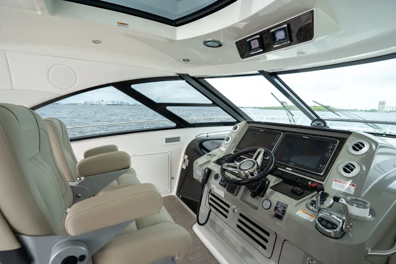 Slide: The Image of Luxurious 2016 Sea Ray Sundancer 540 yacht cockpit with advanced navigation systems and plush seating. - 31