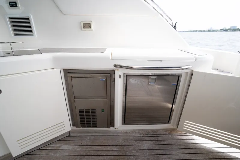 Slide: The Image of 2016 Sea Ray Sundancer 540 yacht kitchenette with open storage and appliances. - 36