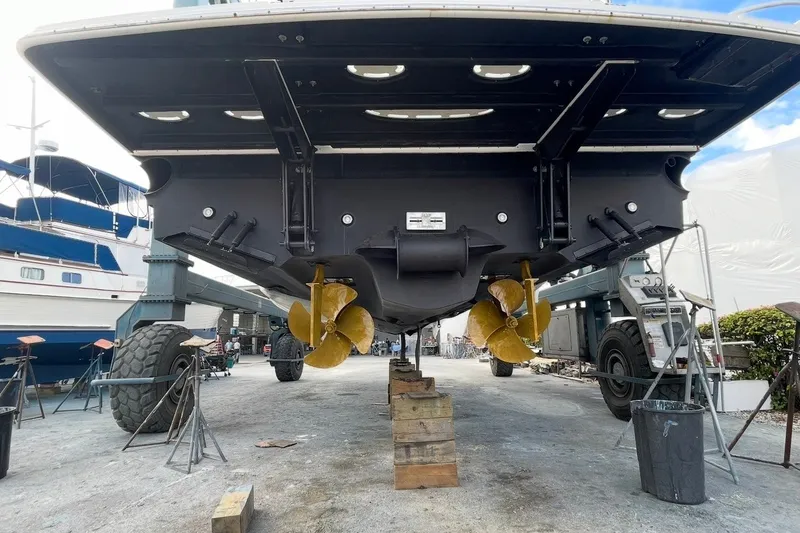 Slide: The Image of 2016 Sea Ray Sundancer 540 yacht on dry dock, showcasing dual propellers and hull structure. - 101