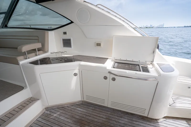 Slide: The Image of Outdoor kitchen on 2016 Sea Ray Sundancer 540 yacht with grill and seating area. - 37