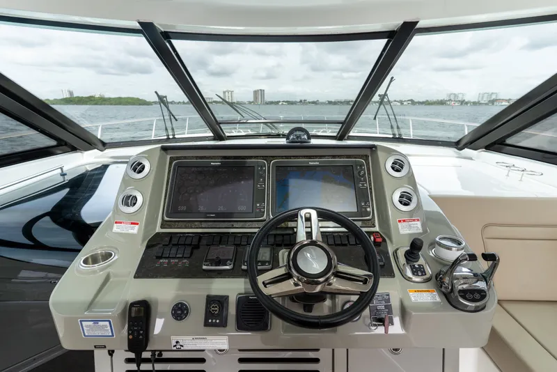 Slide: The Image of Helm of 2016 Sea Ray Sundancer 540 yacht with navigation controls and panoramic view. - 33