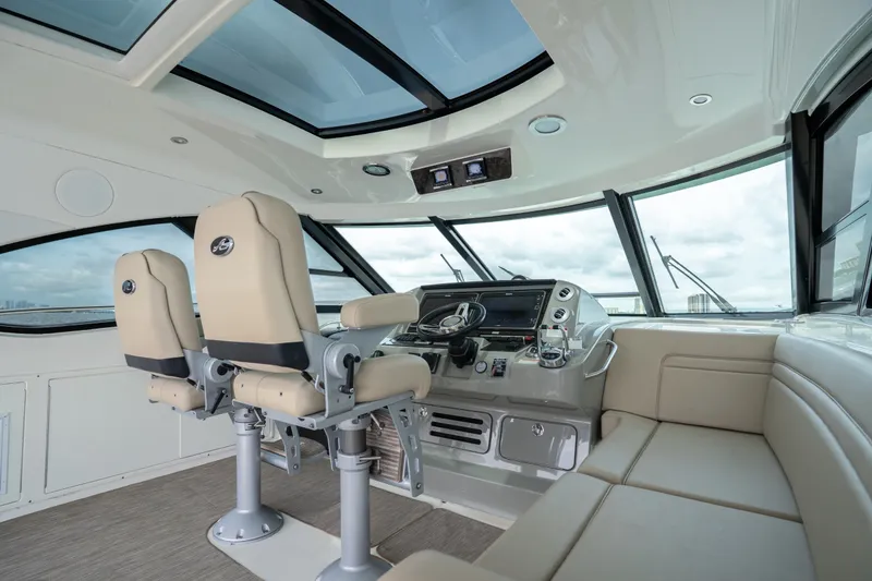Slide: The Image of Luxurious 2016 Sea Ray Sundancer 540 helm with plush seating and panoramic windows. - 28