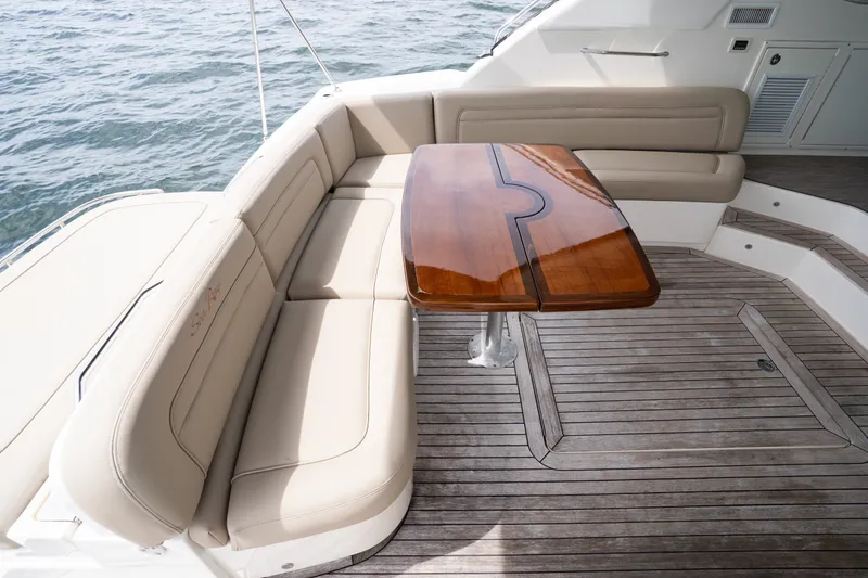 Slide: The Image of Luxurious seating area on 2016 Sea Ray Sundancer 540 yacht with elegant wooden table. - 45