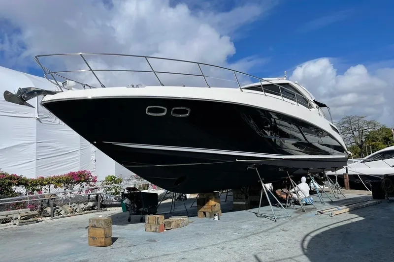 Slide: The Image of 2016 Sea Ray Sundancer 540 yacht on dry dock under a clear blue sky. - 95