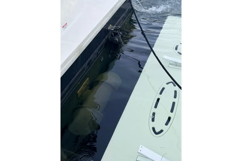 Slide: The Image of 2016 Sea Ray Sundancer 540 docked, showing hull and water reflection. - 52