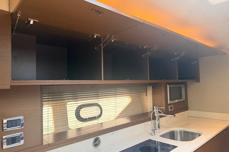 Slide: The Image of Luxurious 2016 Sea Ray Sundancer 540 yacht kitchen with modern appliances and sleek cabinetry. - 56