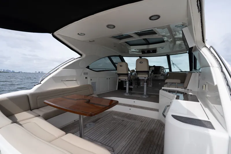 Slide: The Image of Luxurious 2016 Sea Ray Sundancer 540 yacht interior with seating and helm, cruising on open water. - 22