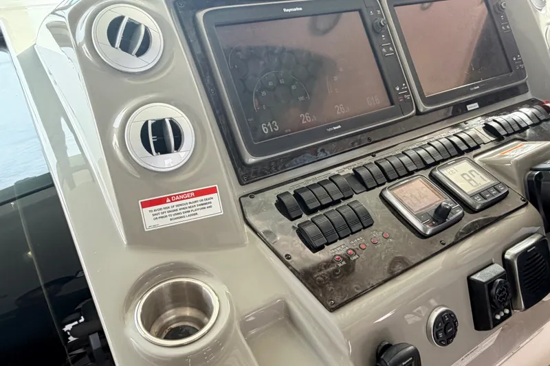 Slide: The Image of Control panel of a 2016 Sea Ray Sundancer 540 yacht with navigation screens and switches. - 25